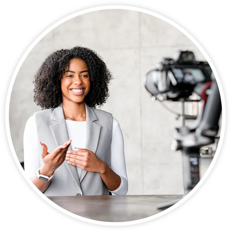 A woman is talking to someone in front of a camera.